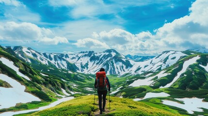 Fototapeta premium Backpacker entering snowy mountain pass 