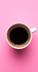 Coffee in white mug on pink backdrop