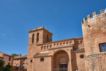 Fototapeta premium The imposing facade of the church and castle in Monteagudo de las Vicarias, a historical treasure of Soria