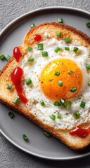 Fried egg in a bread hole, ketchup, and green onions on a gray plate