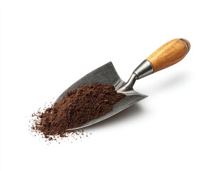 A small, metal garden trowel with a wooden handle holds dark brown soil, spilling slightly onto a white background