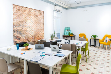 Empty modern coworking office space with meeting tables