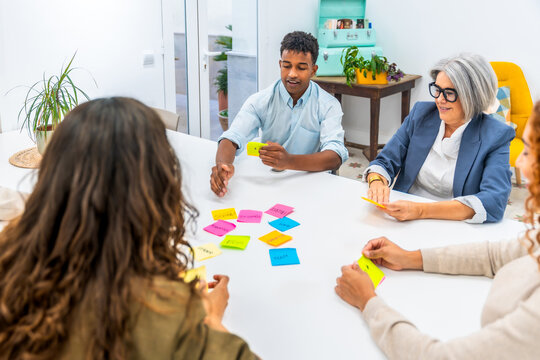 Diverse team brainstorming new ideas using sticky notes