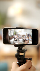 Smartphone on Tripod Recording a Group Meeting, Capturing Moments and Memories, Mobile Technology for Communication and Collaboration, Online