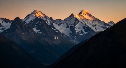 Fototapeta premium Majestic Mountain Peaks Bathed in Golden Light at Sunset.