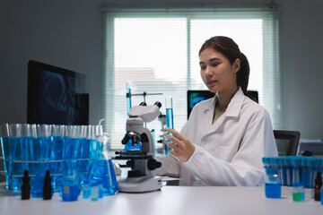 Fototapeta premium Young asian scientist conducting research in laboratory