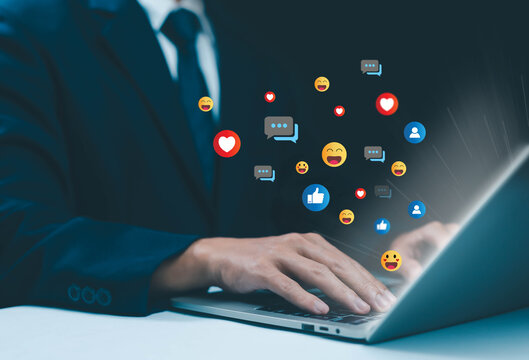 Businessman using laptop with social media icons floating, representing digital marketing, online communication, engagement, and social network interaction for business growth. - Powered by Adobe