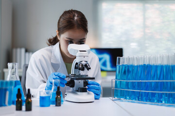 Female scientist conducting research using laboratory microscope