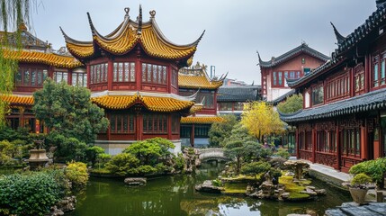 Naklejka premium Traditional Chinese architecture with golden rooftops in a classical garden setting.