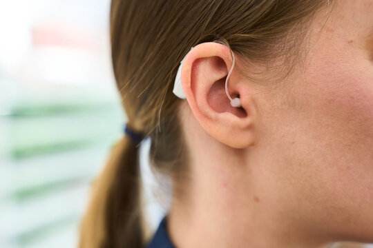 Woman wearing modern bte hearing aid