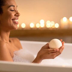 Smiling woman holds bath bomb in a candlelit tub