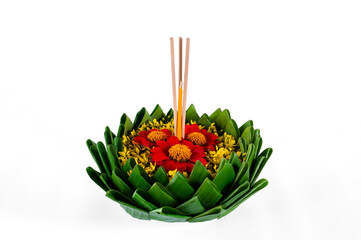 Banana leaf Krathong that have 3 incense sticks and candle decorates with red and yellow flowers for Loy Krathong festival isolated on white paper background.