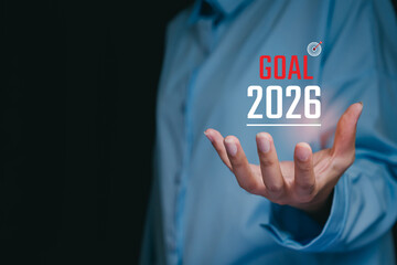 Goal 2025 concept. Person Offering Future Goal Vision for 2026 with Target Symbol in Focus and Inspirational Gesture in Dark Environment