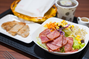 Plate of fried chicken with bacon salad breakfast