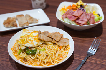 Plate of tomato spaghetti with bacon salad breakfast