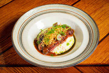 Tender beef on creamy mashed potatoes, drizzled with savory sauce and fresh herbs