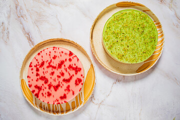 Two beautiful desserts showcase bright red and green layers, inviting all to taste their sweetness