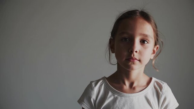 A Thoughtful Young Girl in a Minimalist Setting: Capturing the Essence of Innocence and Curiosity Through Portrait Frames
