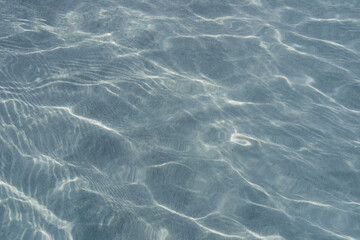 Underwater scene of rippling movement of turquoise water over a sandy seabed