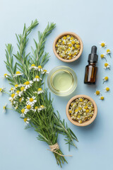 Bottle of essential oil next to flowers