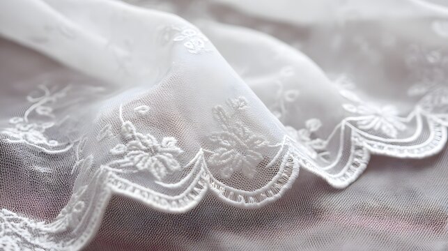 Delicate white lace fabric with intricate floral embroidery showcases a soft texture, creating a dreamy aesthetic with folds and subtle shadows, evoking notions of elegance and sophistication in the.