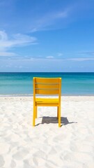 Fototapeta premium Yellow chair on a beach