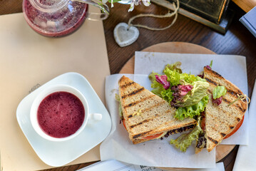 breakfast sandwich grilled on a wooden round board