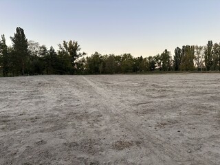 Leveled empty building site in open area in park