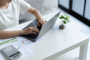 woman calculates tax invoices at home to plan her financial budget effectively