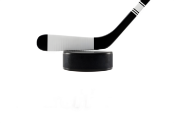 A close-up of a black ice hockey stick blade with white tape resting on top of a puck, isolated on a white background.