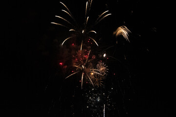 Golden Fireworks Explosion in Night Sky. New Year's Eve Celebration or Festival Pyrotechnics Background.