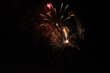 Golden Fireworks Explosion in Night Sky. New Year's Eve Celebration or Festival Pyrotechnics Background.