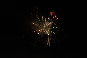 Golden Fireworks Explosion in Night Sky. New Year's Eve Celebration or Festival Pyrotechnics Background.