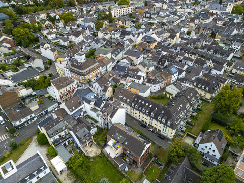 Aerial view of rooftops and streets interlock, forming a tapestry of urban life in Koenigswinter, North Rhine-Westphalia, Germany.