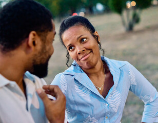 Obraz premium Portrait of a happy young couple, woman and man, black couple having fun walking and talking holding hands and bonding in park outdoors