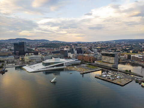 Aerial view of the Barcode buildings, the Opera House, and the harbor's tranquil waters reflecting the sky's soft hues, Oslo, Oslo, Norway.