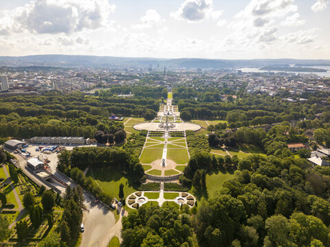 Aerial view of Vigeland Sculpture Arrangement contrasts with the lush green of Frogner Park stretching towards the city skyline, Oslo, Oslo, Norway.