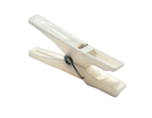 Off-white plastic clothing pin, open, resting on black background