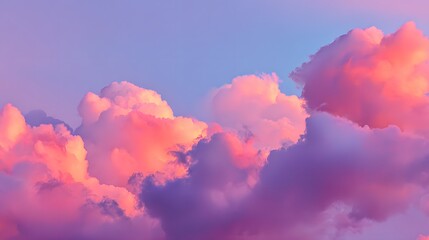Majestic cloud formations are illuminated by the warm glow of the setting sun, creating an ethereal spectacle of vibrant colors across the serene sky, with hues of pink and purple.