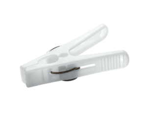 A single, white plastic clamp on a black background, spring inside, open and ready