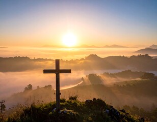 Sunrise over misty mountains with wooden cross