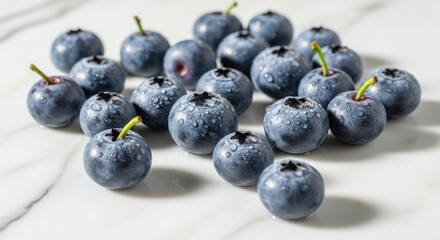 Fresh ripe blueberries scattered on a white marble surface healthy food
