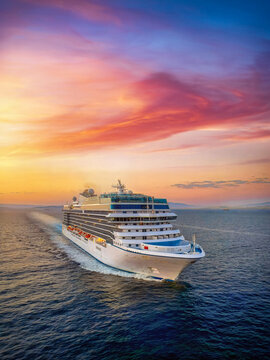 Aerial view of a generic cruise ship traveling over the ocean during golden summer sunset time with copy space