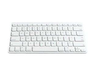 Angled view of a wireless, white keyboard with a sleek, minimalist design on black