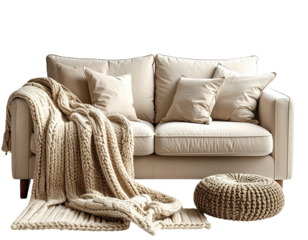 Cozy beige couch with cushions, a knitted blanket, and a woven ottoman