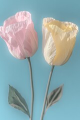 Two pastel paper tulips, pink & yellow, stems, leaves