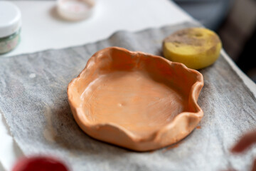 on a wooden table there is a blank for a handmade clay plate