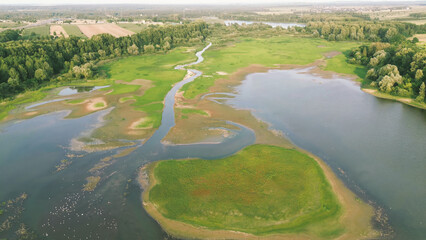 Green fields with winding river and woodland