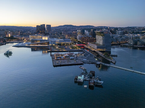 Aerial view of the Oslo Opera House and the Munch Museum reflected in the calm waters of the Oslofjord at dusk, Oslo, Oslo, Norway.