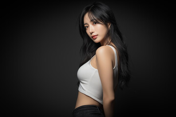 Fototapeta premium Elegant young Korean woman in white sleeveless top studio portrait